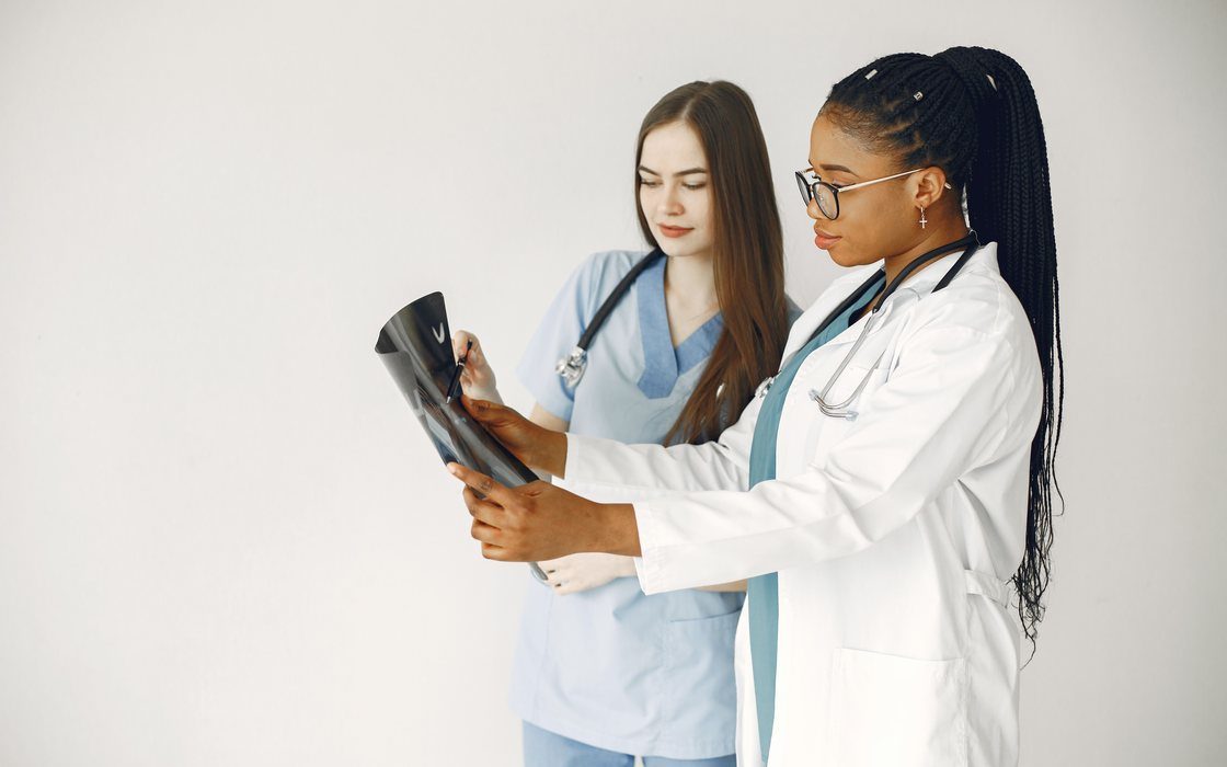 Two clinicians reviewing a patient X-ray together