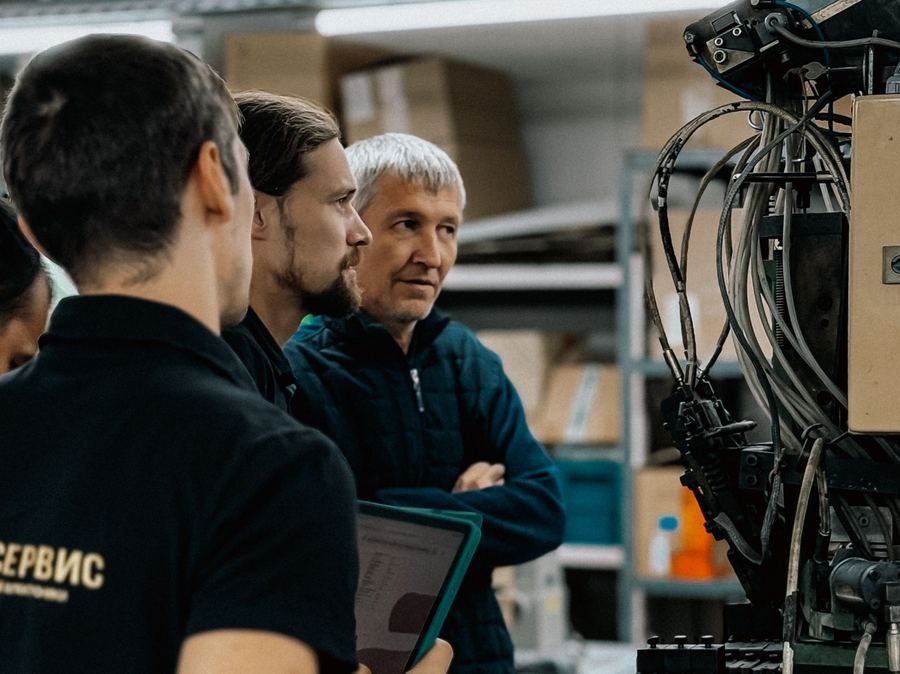 Technical specialists reviewing equipment with a tablet