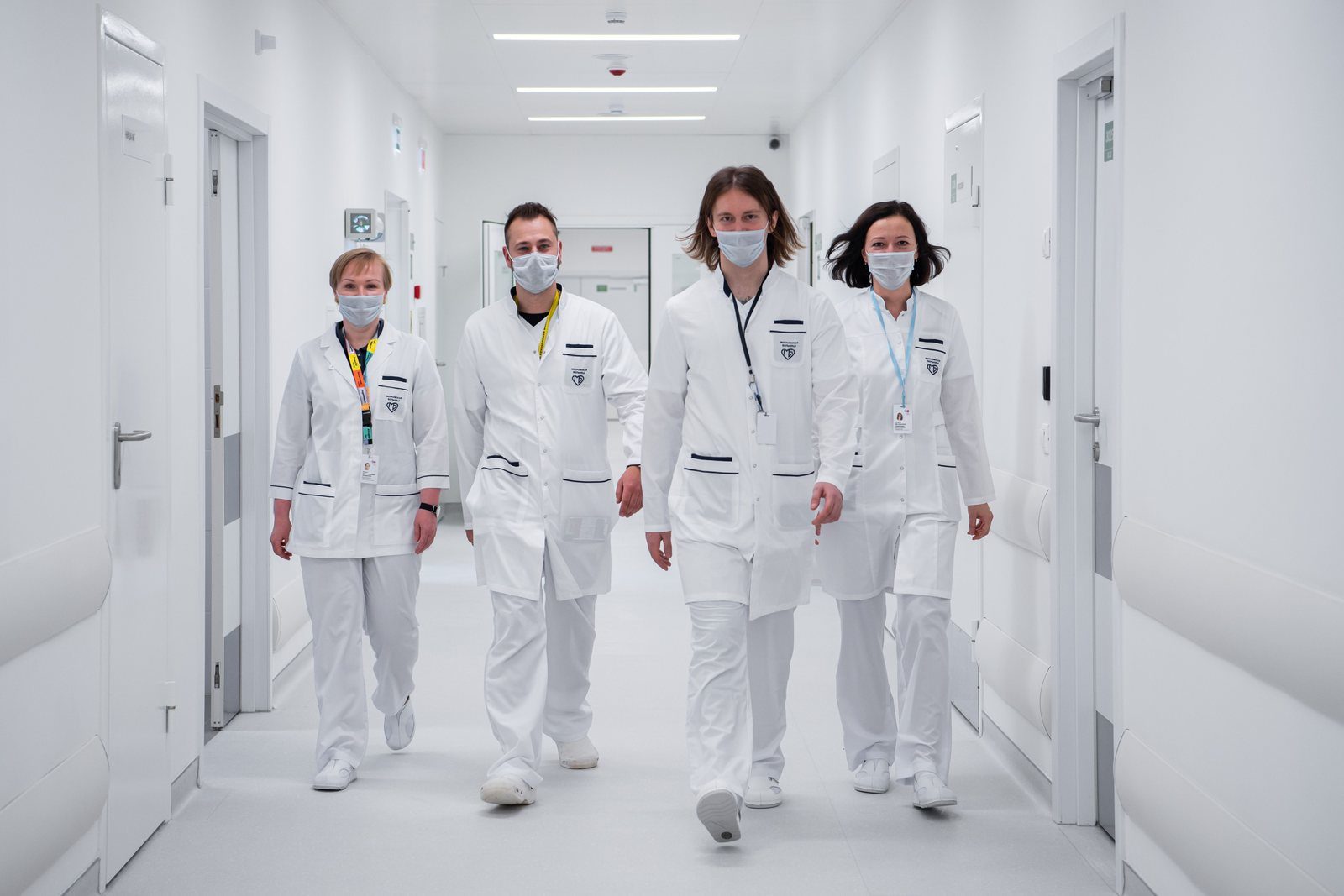 A team of hospital staff walking through a modern clinical corridor
